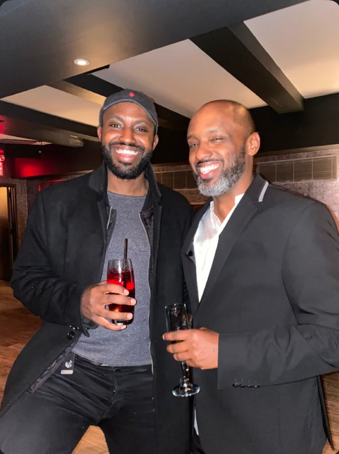 Two men smiling together with drinks